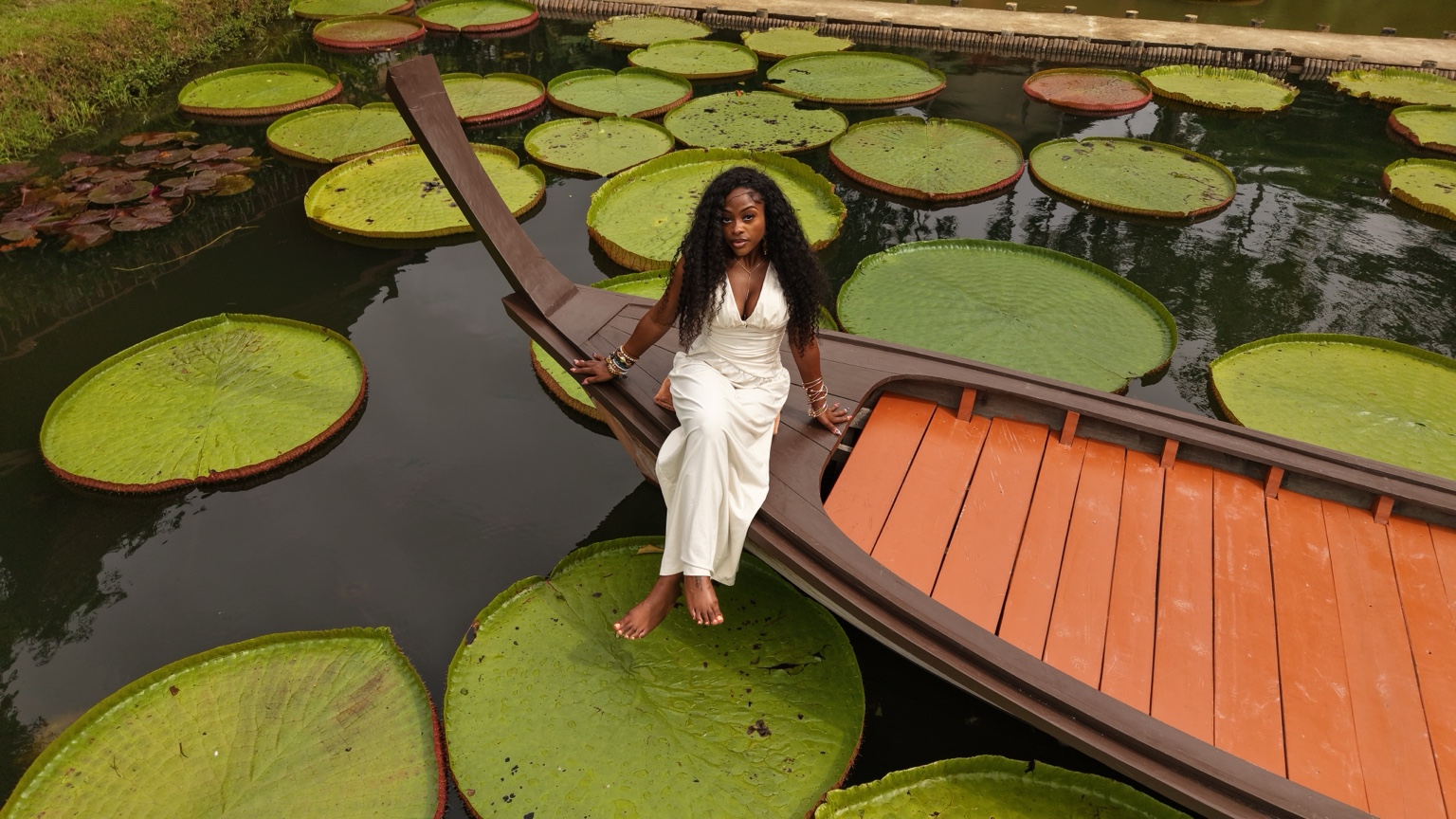 A Plus Trips traveler surrounded by giant lily pads in Thailand