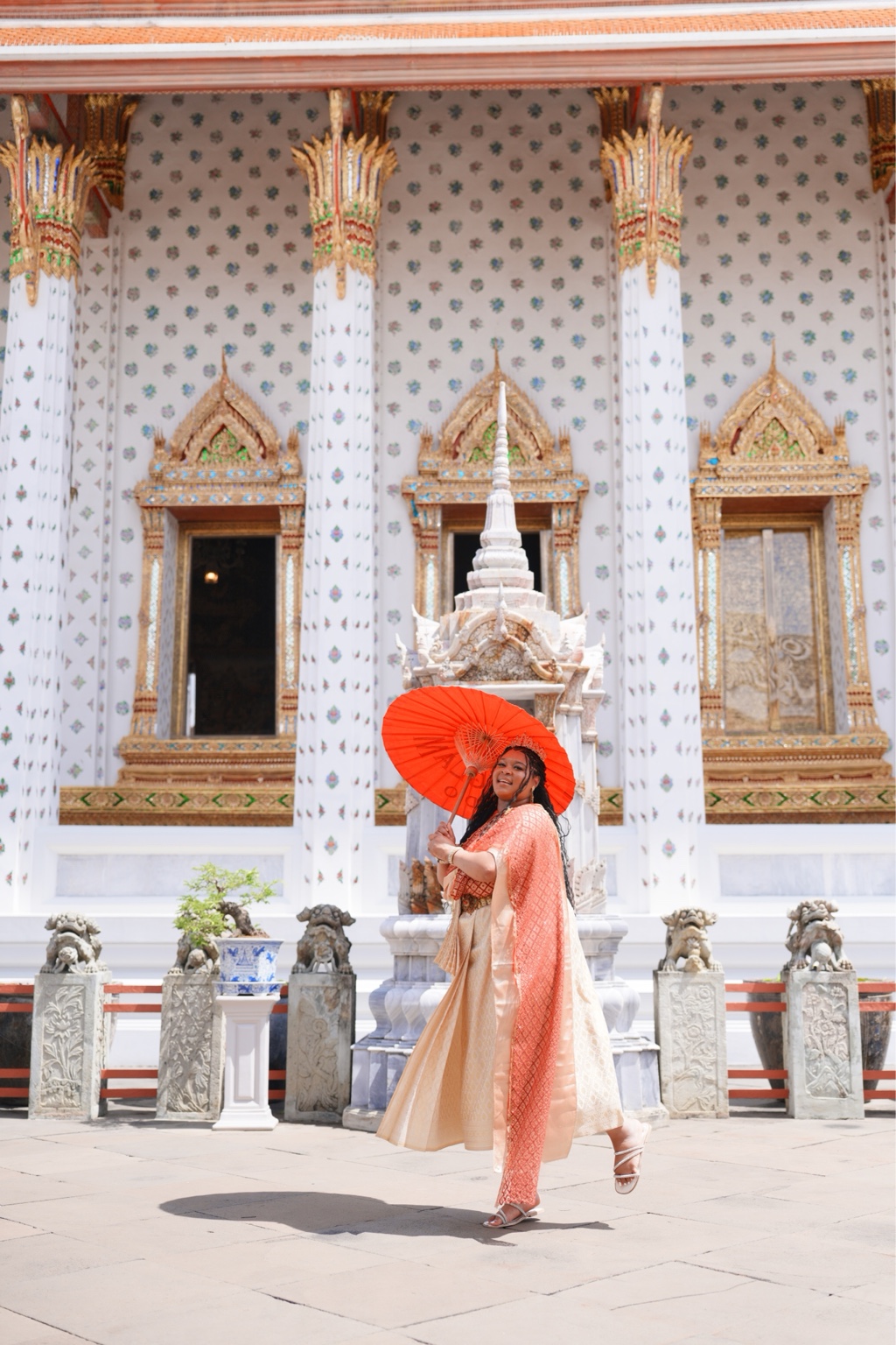 A Plus traveler dressed for a temple experience in Thailand